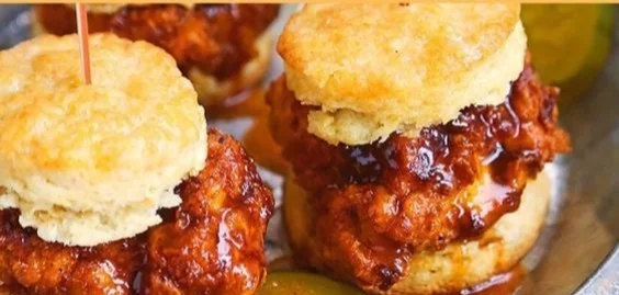 Delicious Hot Honey Chicken Biscuits served on a plate with honey drizzle