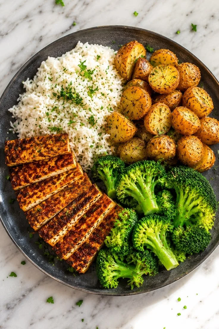 A vibrant plant-based dinner plate featuring colorful vegetables and grains.